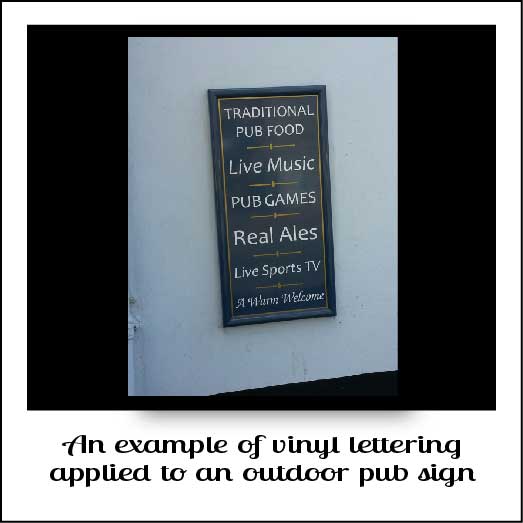 An outdoor pub sign with vinyl letters